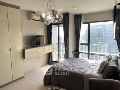 Luxurious bedroom with city view, modern decor, and stylish lighting in high-rise apartment.