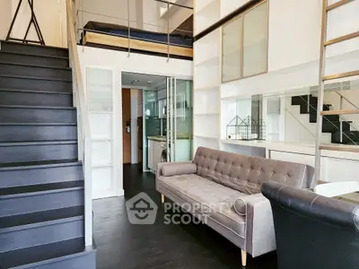 Modern loft apartment with stylish staircase and cozy living area