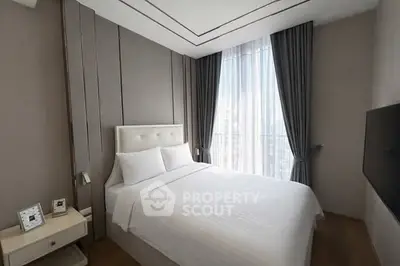 Elegant bedroom with modern decor and large window for natural light