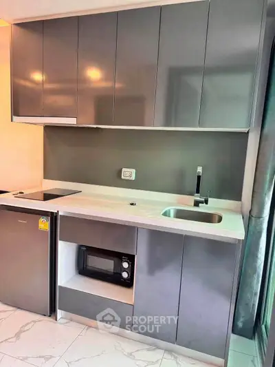 Modern kitchen with sleek cabinetry and built-in appliances in a stylish apartment.