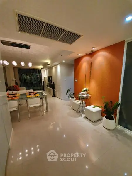 Modern living room with dining area and stylish decor in a contemporary apartment.