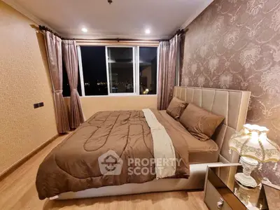 Luxurious bedroom with elegant decor and city view window, perfect for relaxation.
