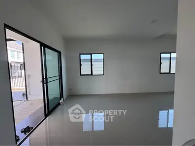 Spacious modern living room with large windows and sleek tile flooring