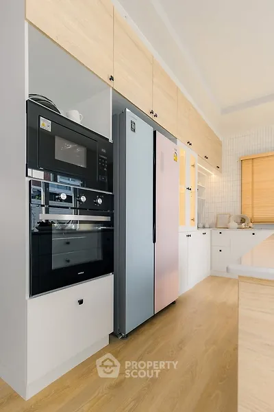 Modern kitchen with sleek appliances and wooden cabinetry