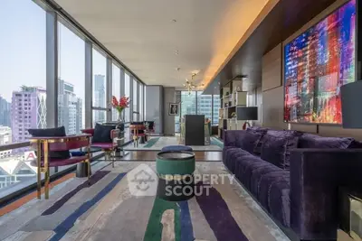 Luxurious modern living room with city view, elegant decor, and vibrant artwork.