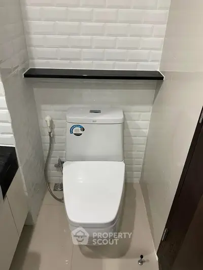 Modern bathroom with sleek white toilet and stylish tile design