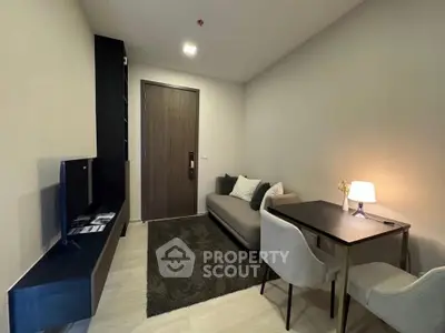 Modern living room with cozy sofa and dining area in a stylish apartment.