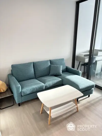 Modern living room with stylish blue sofa and sleek coffee table