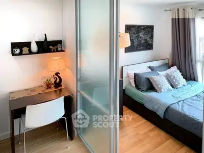 Modern bedroom with study area featuring sliding glass partition and stylish decor.
