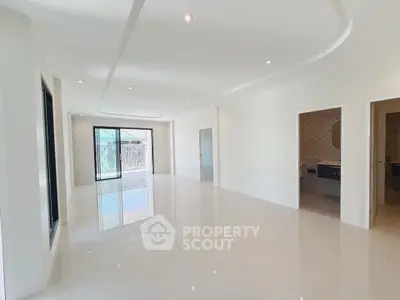 Spacious modern living room with glossy floors and elegant lighting