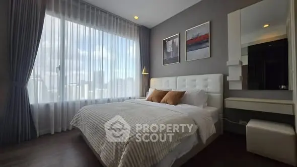 Luxurious bedroom with large window and elegant decor in modern apartment