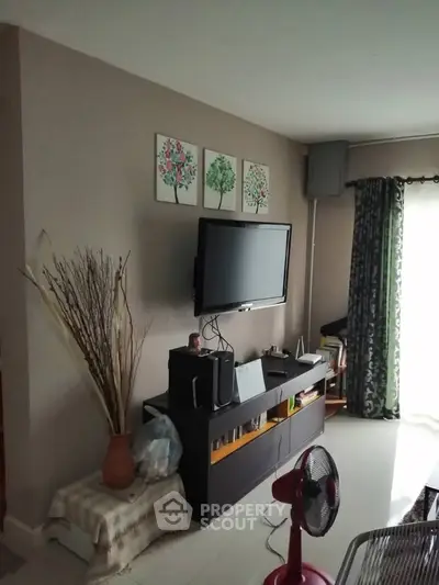 Cozy living room with wall-mounted TV and stylish decor