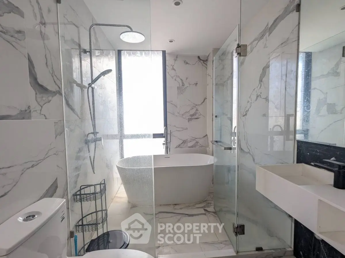 Luxurious marble bathroom with modern fixtures and freestanding bathtub