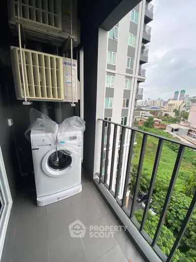 Modern balcony with washing machine and city view in high-rise apartment