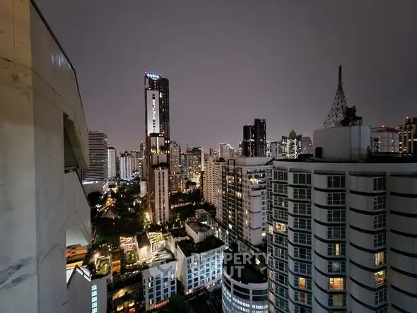 Stunning cityscape view from high-rise building at night showcasing urban skyline.