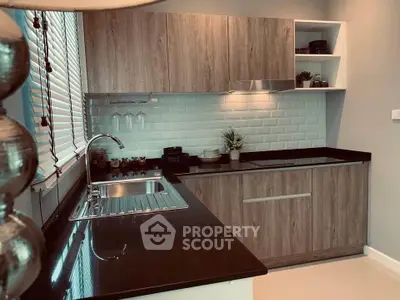 Modern kitchen with sleek black countertops and wooden cabinets