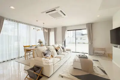 Spacious modern living room with elegant decor and large windows for natural light.