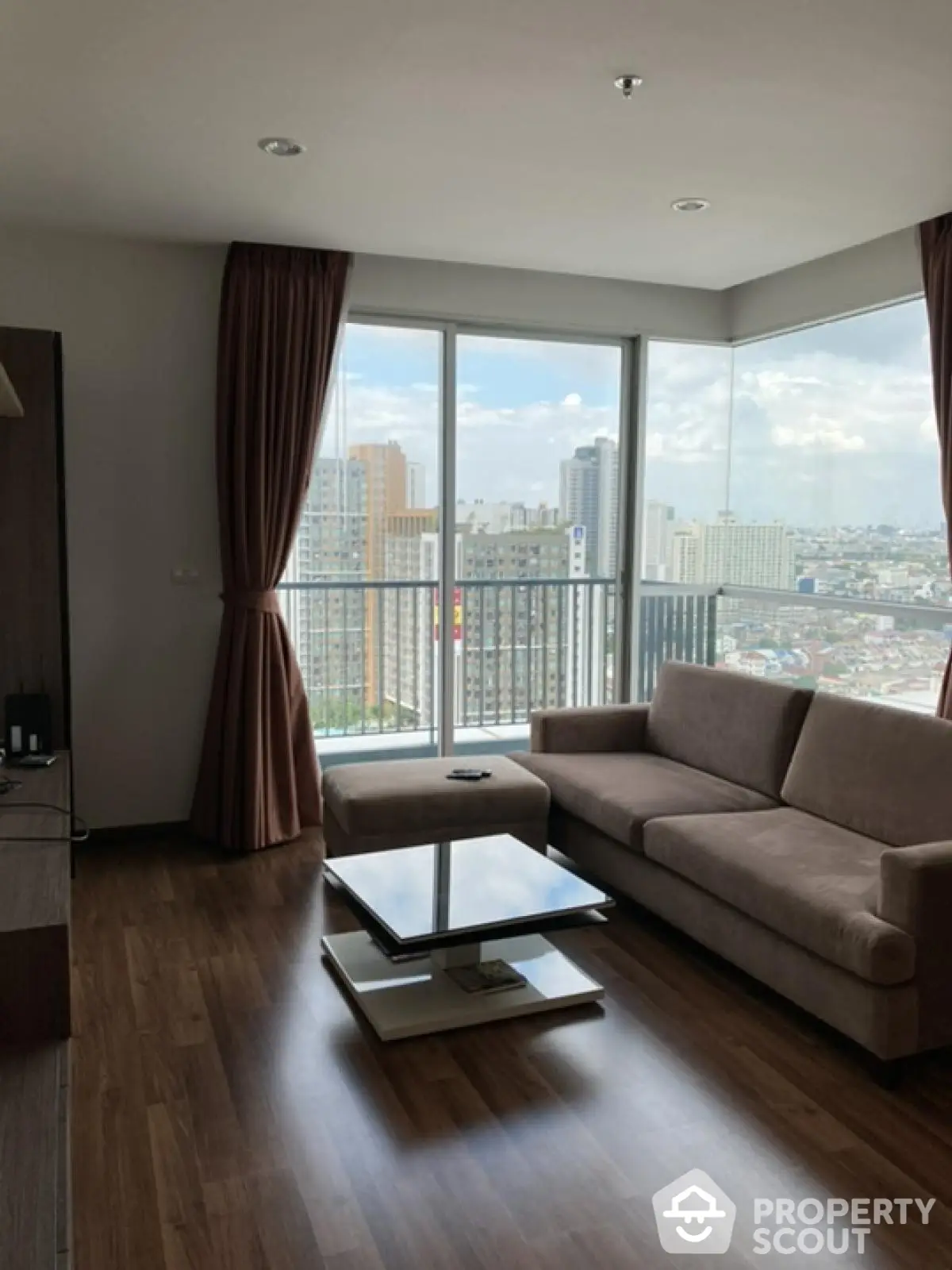 Modern living room with city view and stylish furniture in high-rise apartment