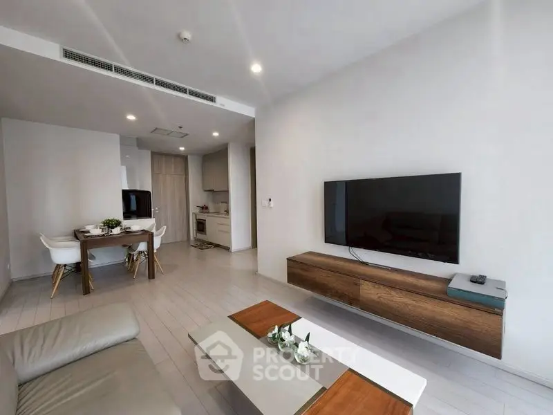 Modern living room with sleek furniture and open kitchen layout