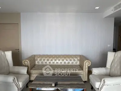 Luxurious living room with elegant leather sofa and armchairs, perfect for sophisticated gatherings.