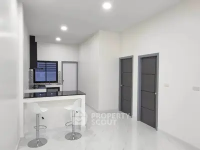 Modern kitchen with sleek design and breakfast bar in a contemporary apartment.
