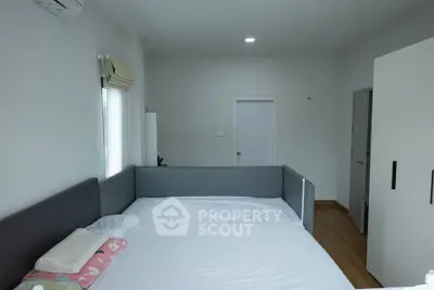 Spacious bedroom with modern decor and ample natural light