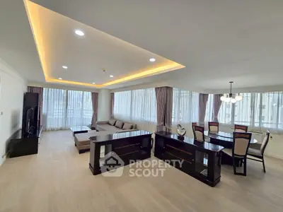 Spacious modern living room with elegant dining area and large windows