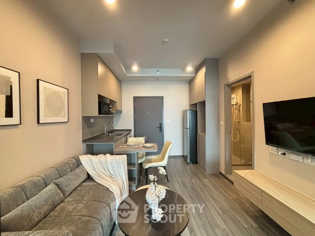 Modern living room with open kitchen layout and stylish decor