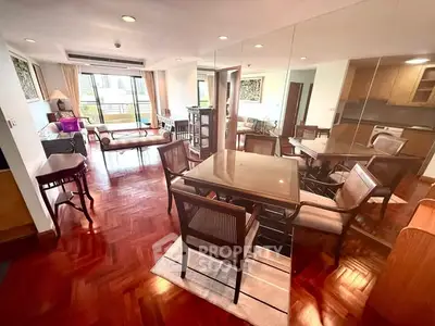 Spacious living room with elegant wooden flooring and modern furniture in a stylish apartment.