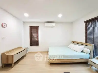 Spacious modern bedroom with minimalist design and natural light