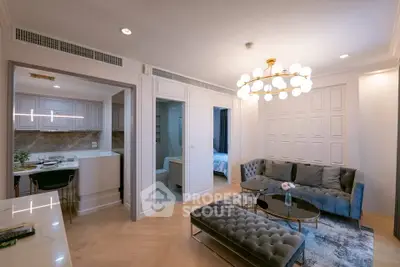 Luxurious modern living room with elegant chandelier and open kitchen layout