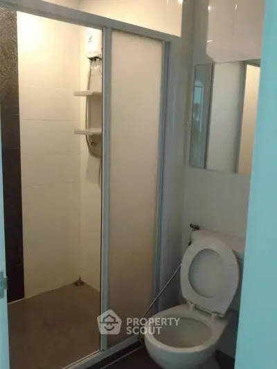Compact bathroom with shower and toilet in modern apartment