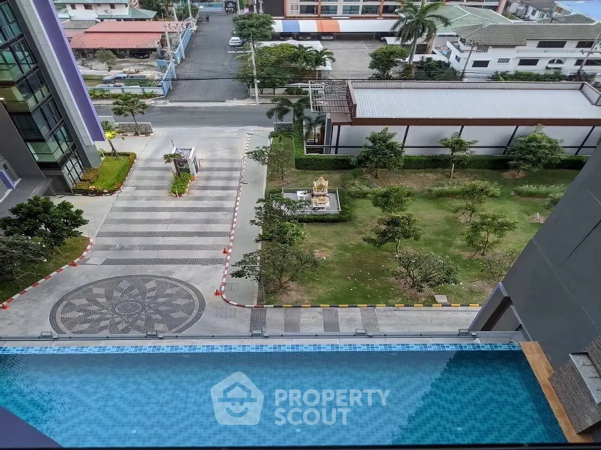 Stunning rooftop pool with city view and lush garden area