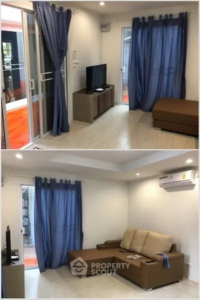 Modern living room with blue curtains and brown sofa, featuring a sleek TV setup.