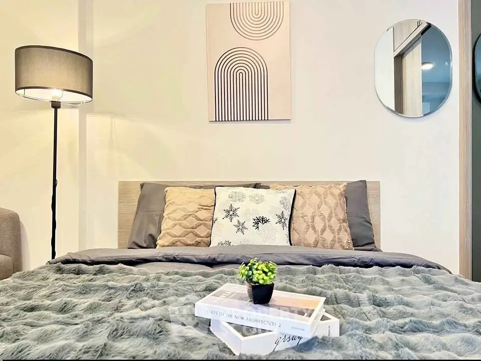 Cozy bedroom with modern decor and plush bedding, perfect for relaxation.