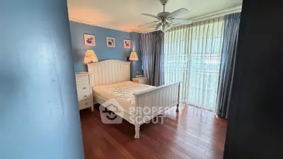 Charming bedroom with elegant decor and natural light, featuring hardwood floors and stylish furnishings.