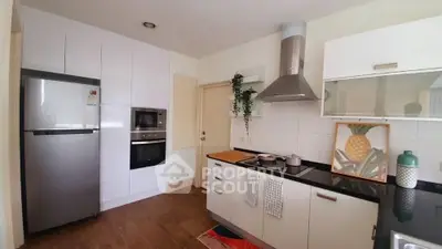 Modern kitchen with sleek appliances and stylish decor in a contemporary home.