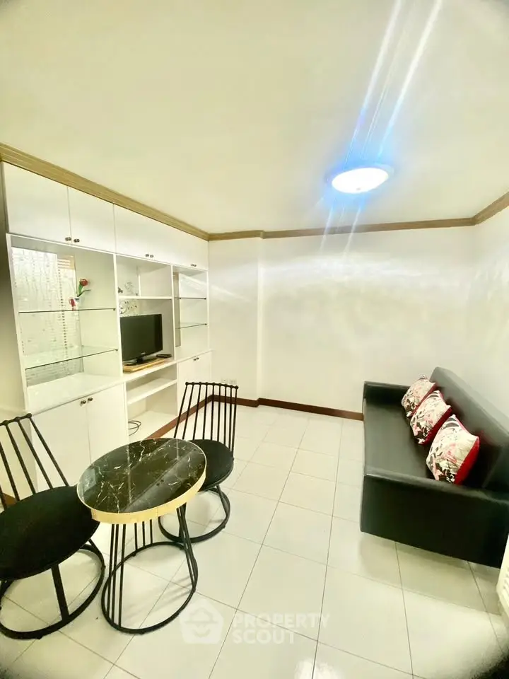 Cozy living room with modern furniture and built-in storage, perfect for relaxation and entertainment.