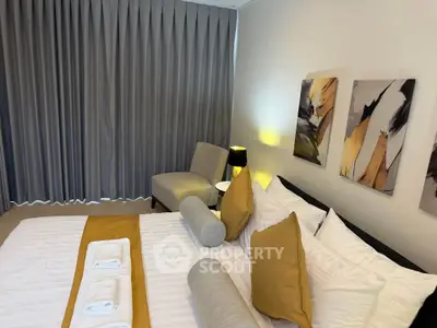 Luxurious bedroom with elegant decor and modern art, featuring plush bedding and ambient lighting.
