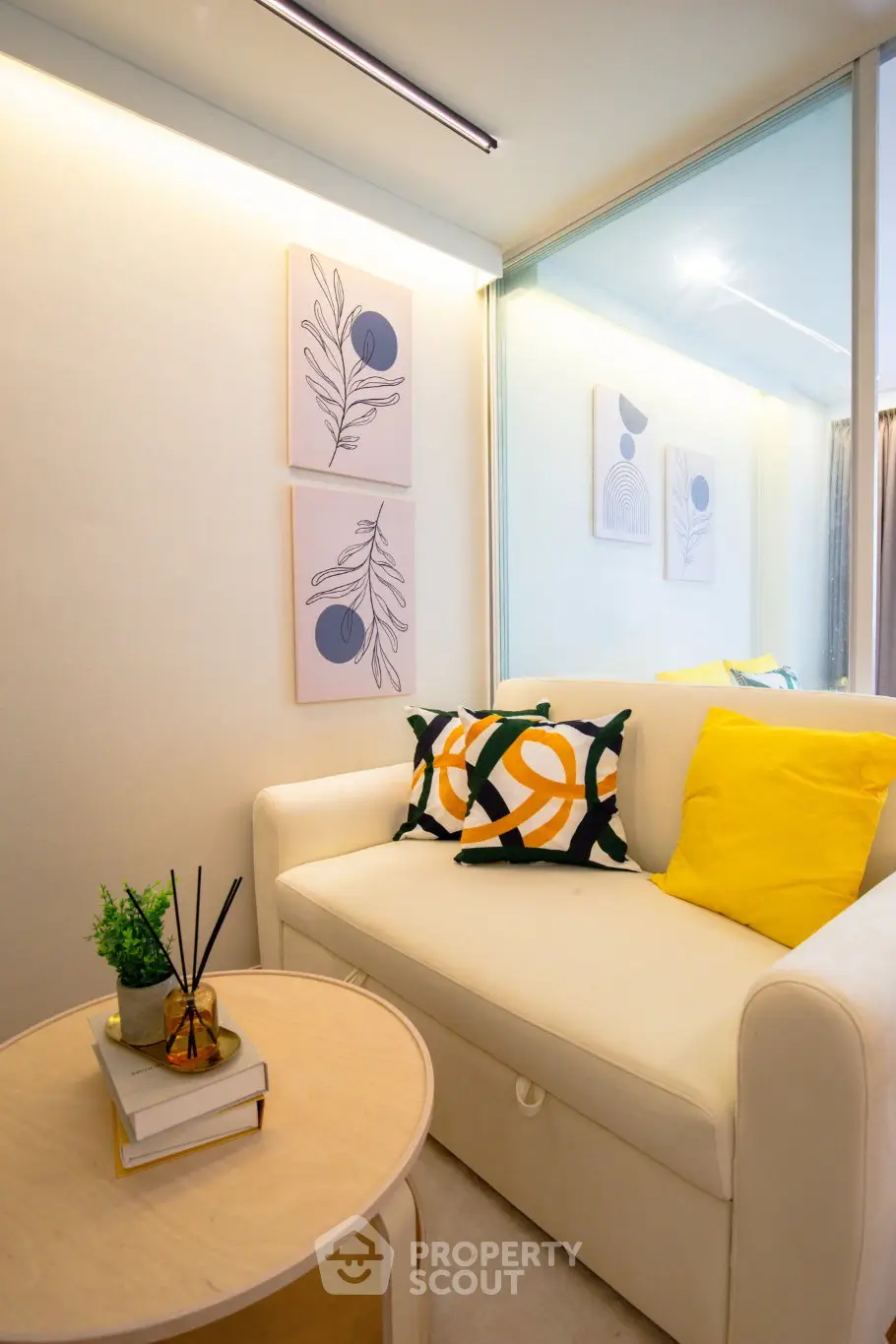 Cozy living room with modern decor and bright accents in a stylish apartment.