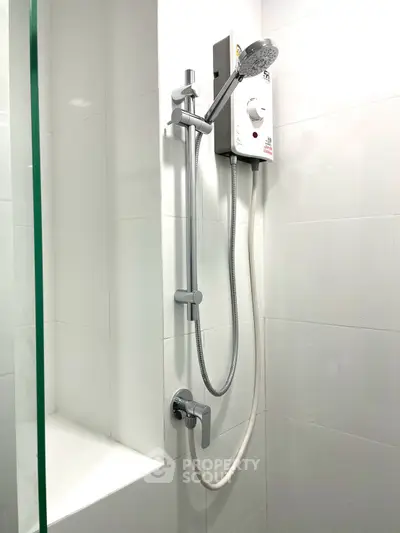 Modern bathroom with sleek shower and white tiles, perfect for a contemporary home.