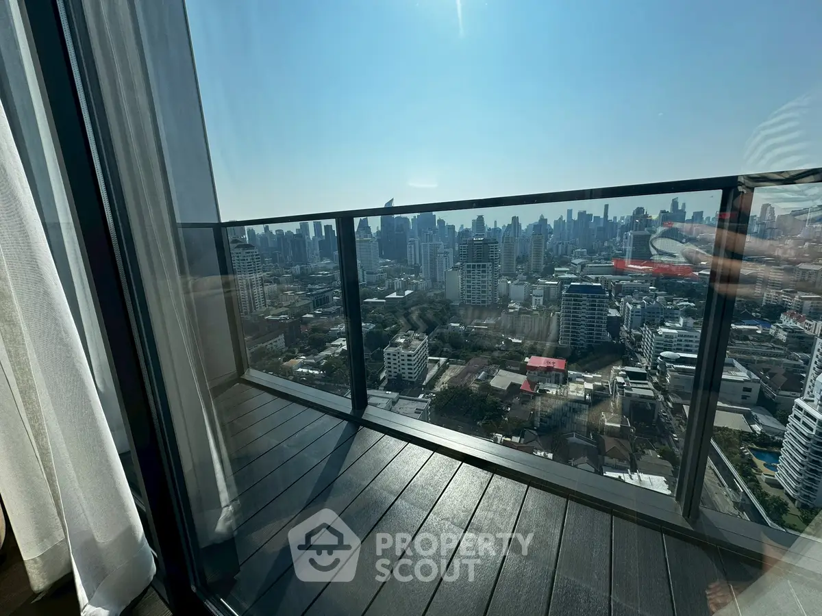 Stunning high-rise balcony with panoramic city skyline view, perfect for urban living enthusiasts.