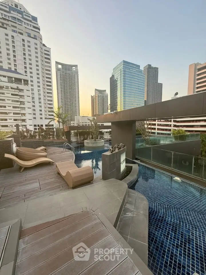 Luxurious rooftop pool with stunning city skyline views at sunset, perfect for relaxation and leisure.