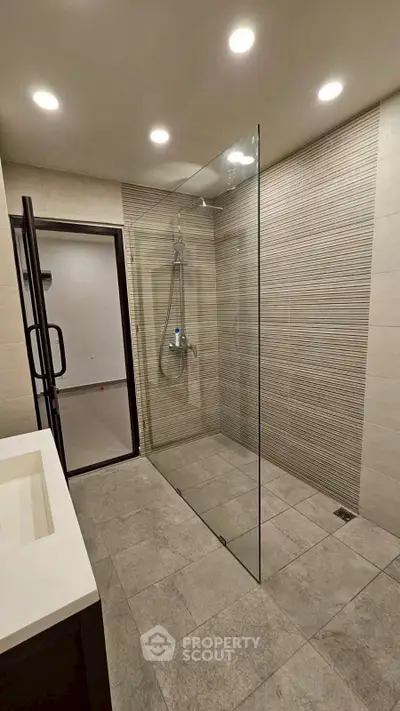 Modern bathroom with sleek glass shower and elegant tile design