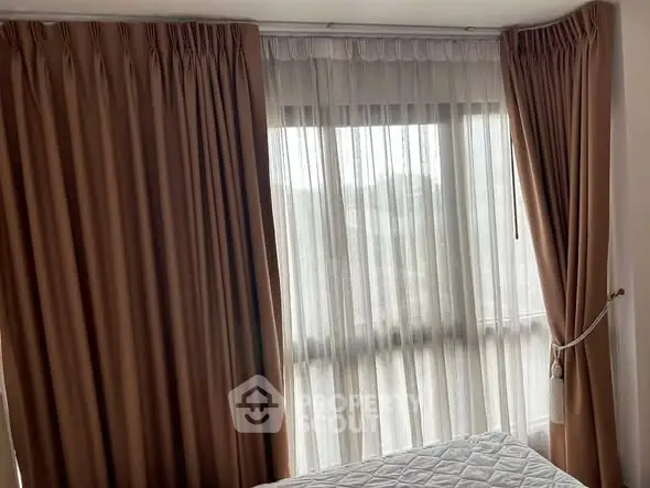 Cozy bedroom with elegant curtains and natural light
