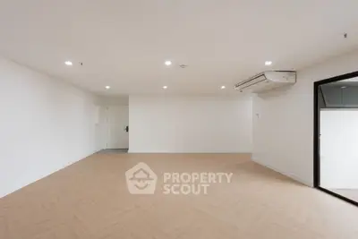 Spacious empty room with modern air conditioning and wooden flooring