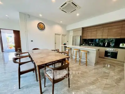 Spacious modern kitchen with dining area and sleek design in open layout