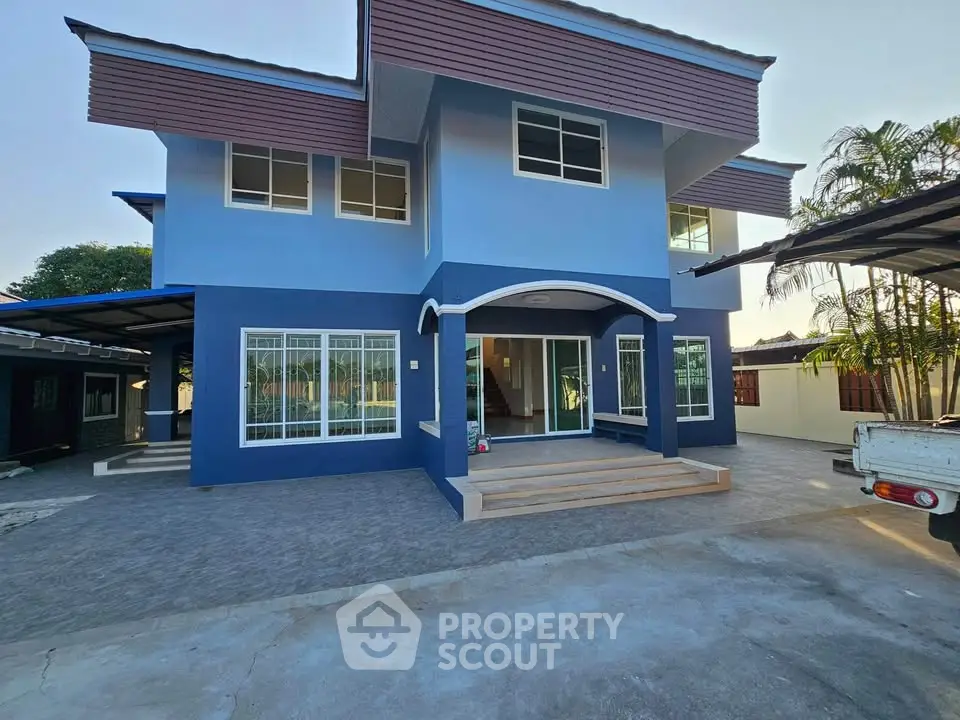 Stunning blue two-story house with modern design and spacious entrance