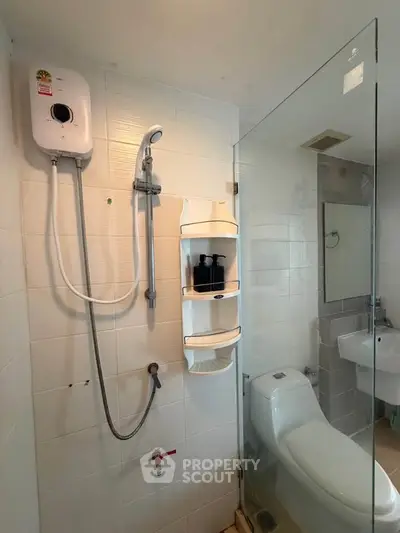 Modern bathroom with glass shower enclosure and wall-mounted water heater.