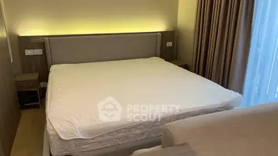 Cozy bedroom with modern design and ambient lighting, featuring a comfortable bed and elegant curtains.